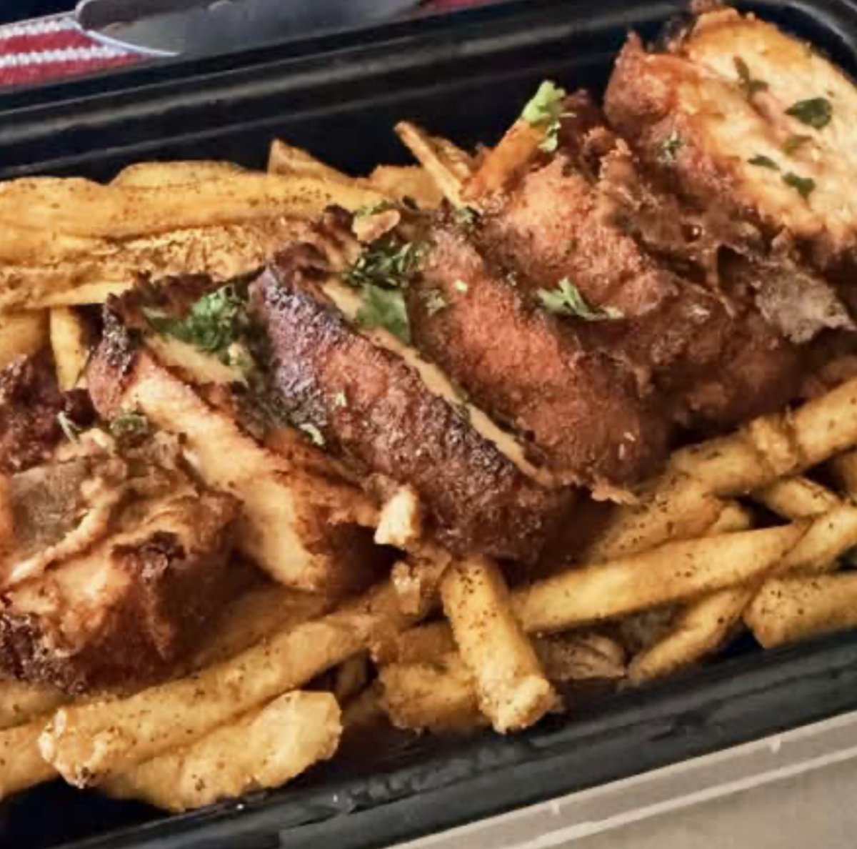 Chicken Cordon Bleu served over seasoned fries.