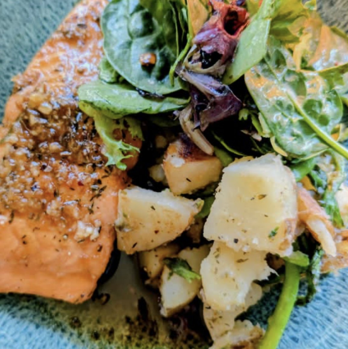Maple Salmon with roasted potatoes and mixed greens.