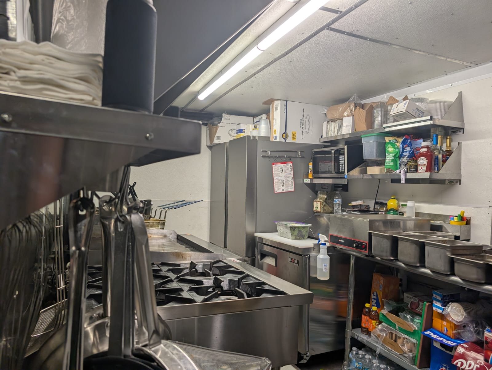 The compact kitchen inside the Chez Leon food truck, fully equipped for bistro-style cooking.